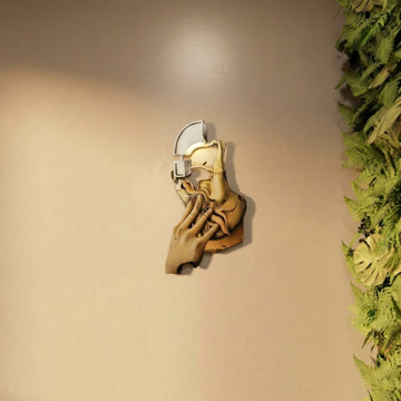 Surrealist silhouette metal wall art on a beige wall next to a green plant wall