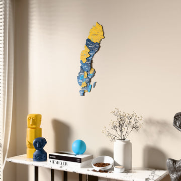 Flag colored Sweden wooden wall map beside a sheer curtain, angled view