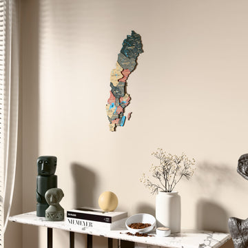 Sage Sweden wooden wall map beside a sheer curtain, angled view