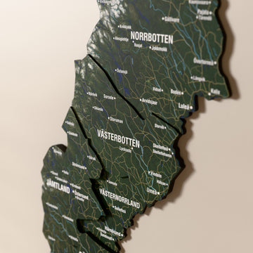 Close-up of the Satellite Sweden wooden wall map with layered regions and printed names