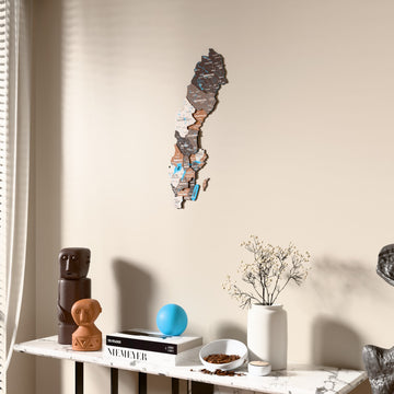 Soil Sweden wooden wall map beside a sheer curtain, angled view