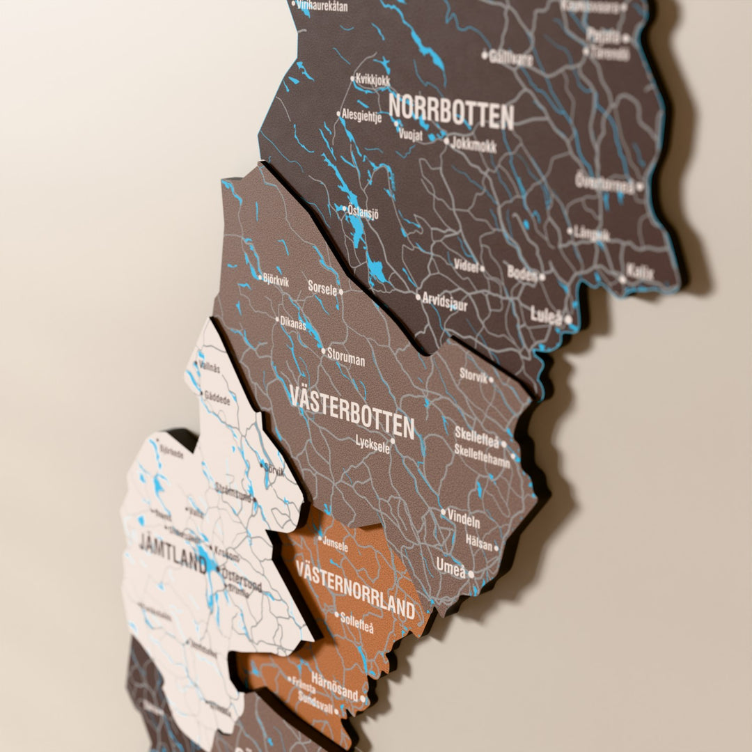 Close-up of the Soil Sweden wooden wall map with layered regions and printed names