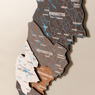 Close-up of the Soil Sweden wooden wall map with layered regions and printed names