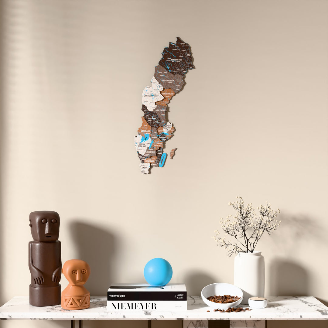 Soil Sweden wooden wall map above a marble console, front view