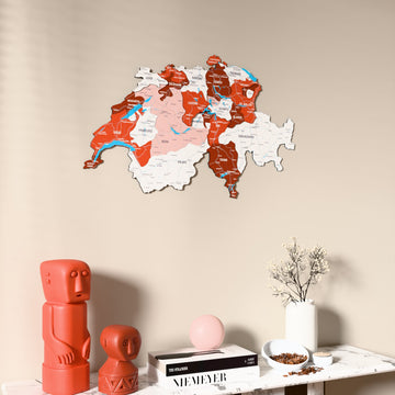 Flag colored Switzerland wooden wall map on a beige wall above a console with figurines