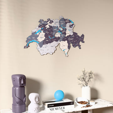 Nimbus Switzerland wooden wall map on a beige wall above a console with figurines