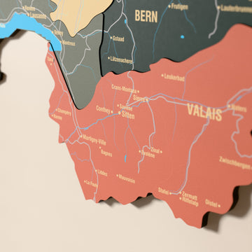 Close-up of the Sage Switzerland wooden wall map with layered regions and printed names