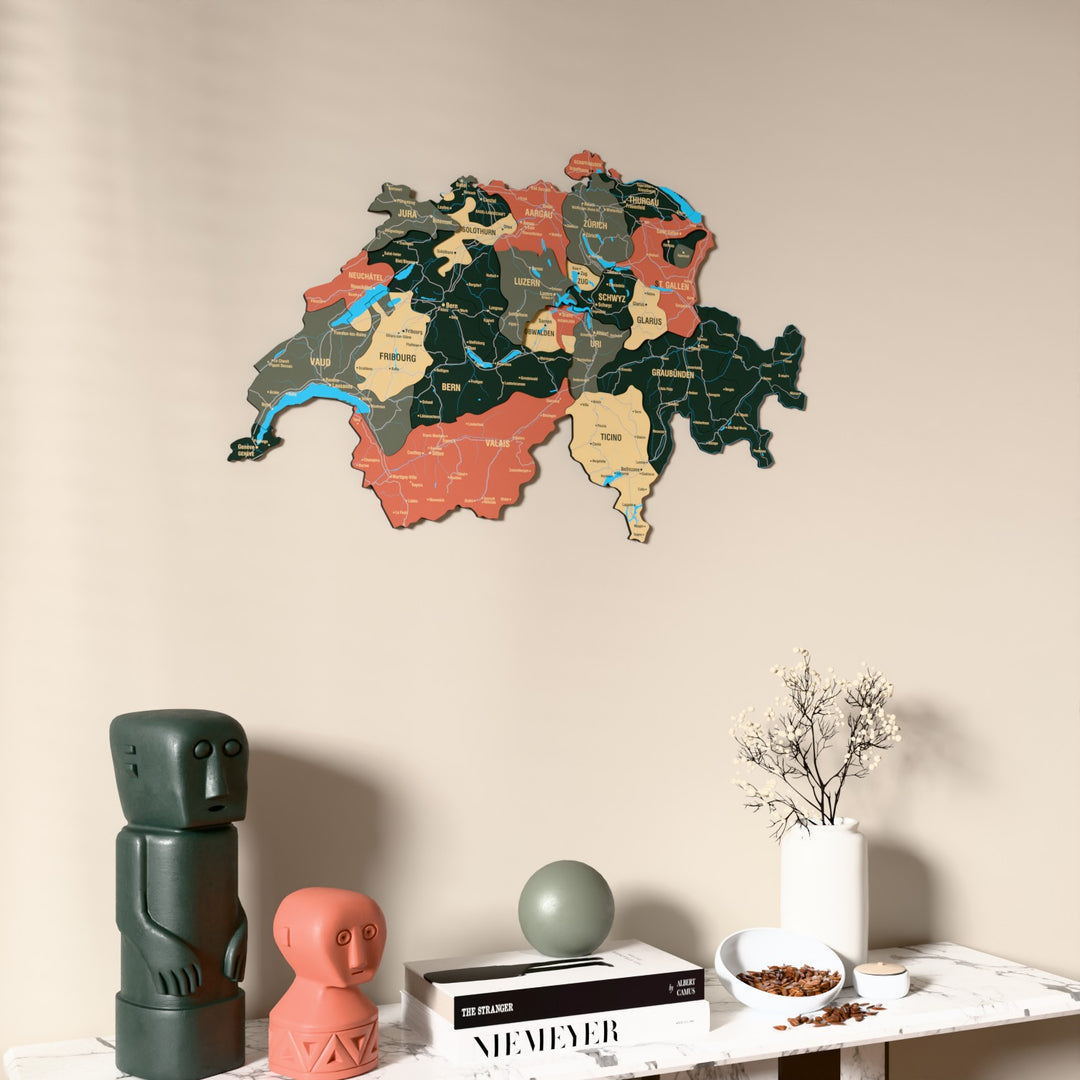 Sage Switzerland wooden wall map on a beige wall above a console with figurines