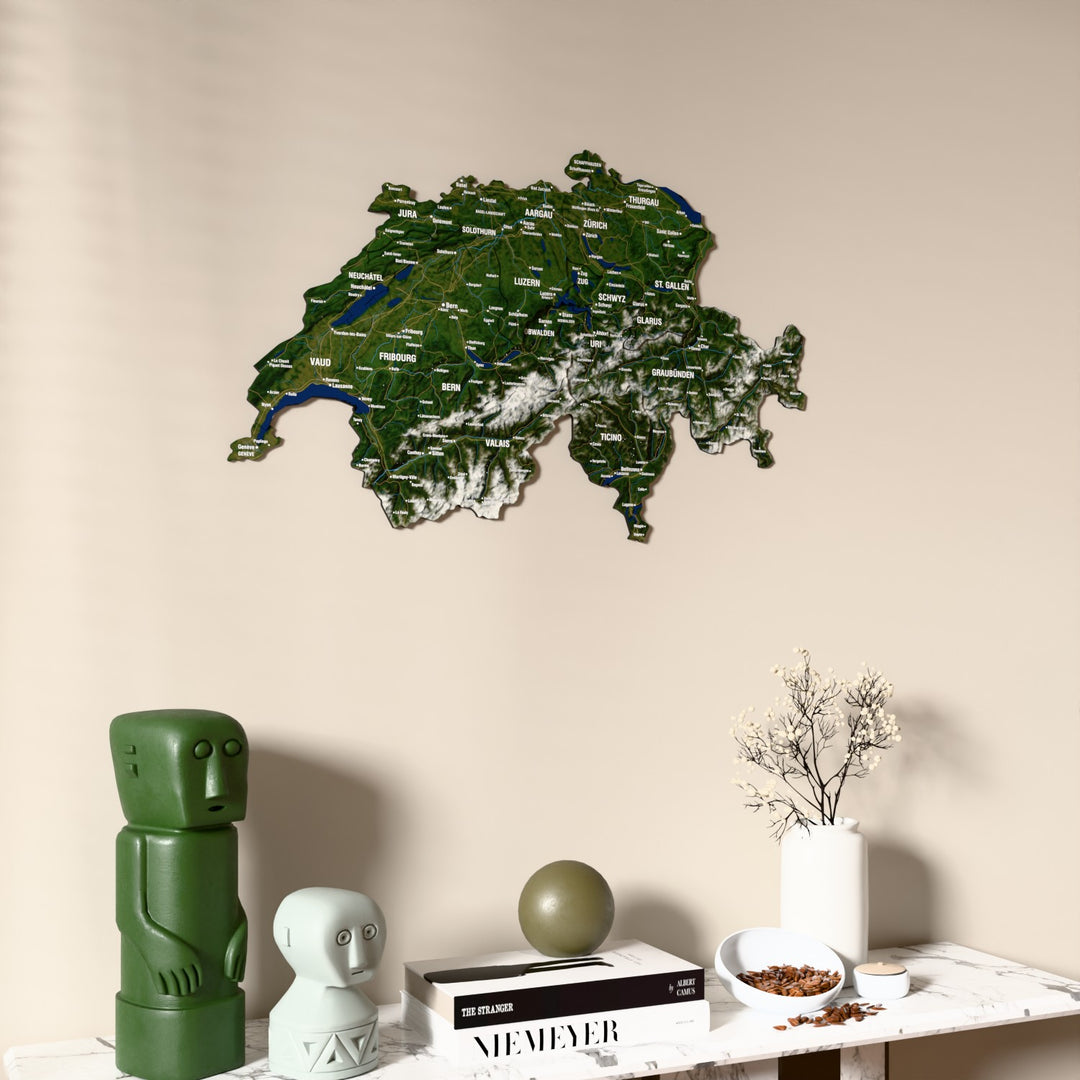 Satellite Switzerland wooden wall map on a beige wall above a console with figurines