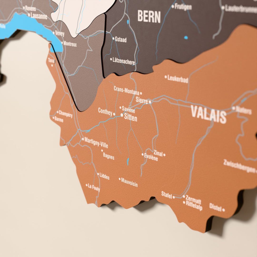 Close-up of the Soil Switzerland wooden wall map with layered regions and printed names