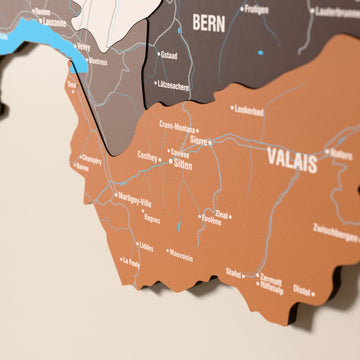 Close-up of the Soil Switzerland wooden wall map with layered regions and printed names