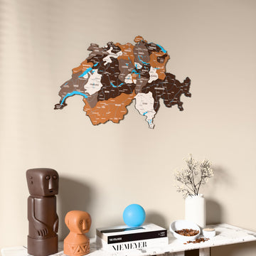 Soil Switzerland wooden wall map on a beige wall above a console with figurines