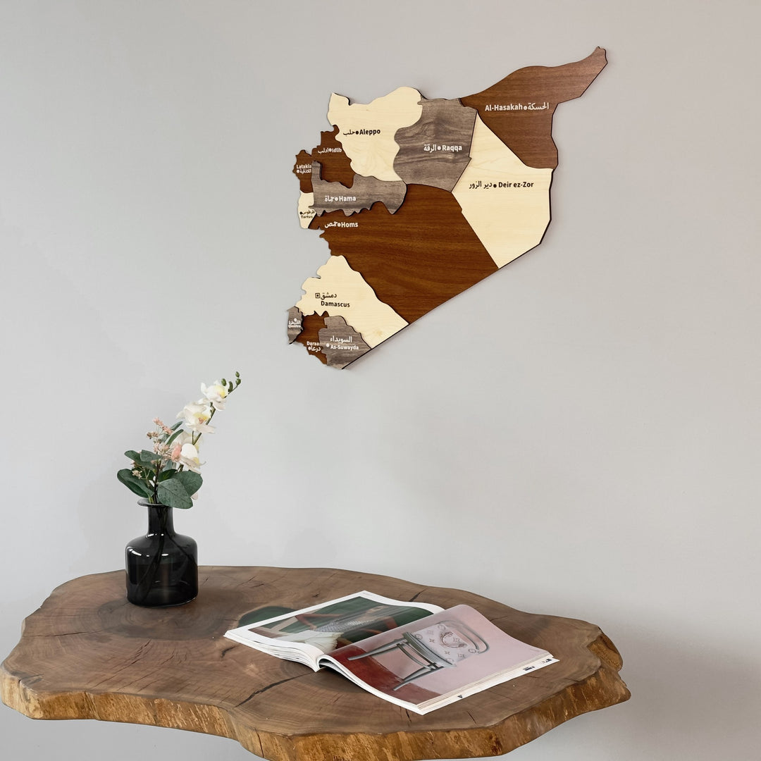 Syria layered wood map above a rustic table with a magazine, seen from a low left angle