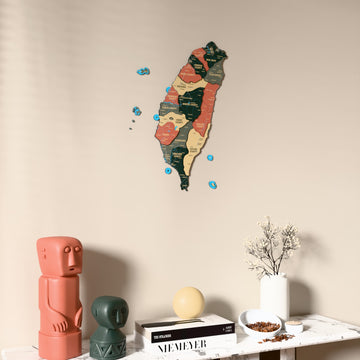 Sage Taiwan wooden wall map on a beige wall above a console with figurines