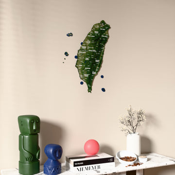 Satellite Taiwan wooden wall map on a beige wall above a console with figurines