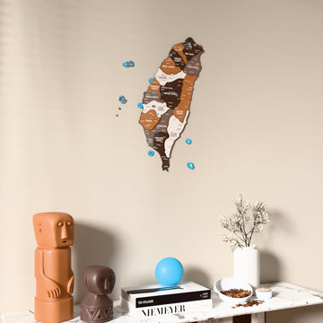 Soil Taiwan wooden wall map on a beige wall above a console with figurines