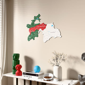 Flag colored Tajikistan wooden wall map beside a sheer curtain, angled view