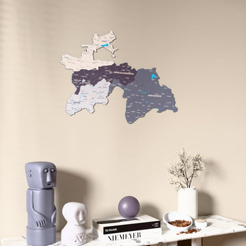 Nimbus Tajikistan wooden wall map on a beige wall above a console with figurines