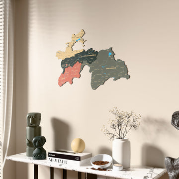 Sage Tajikistan wooden wall map beside a sheer curtain, angled view