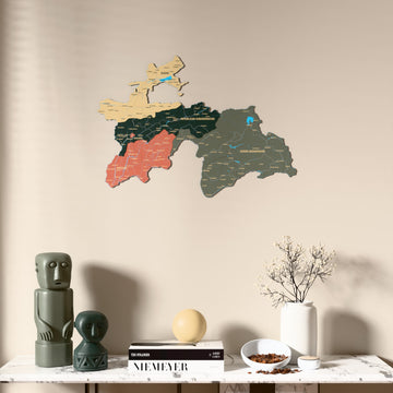 Sage Tajikistan wooden wall map above a marble console, front view