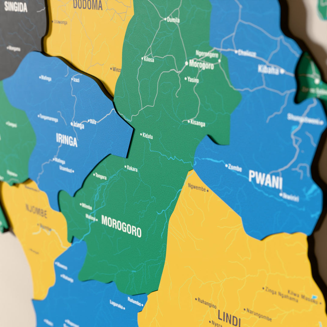Close-up of the Flag colored Tanzania wooden wall map with layered regions and printed names