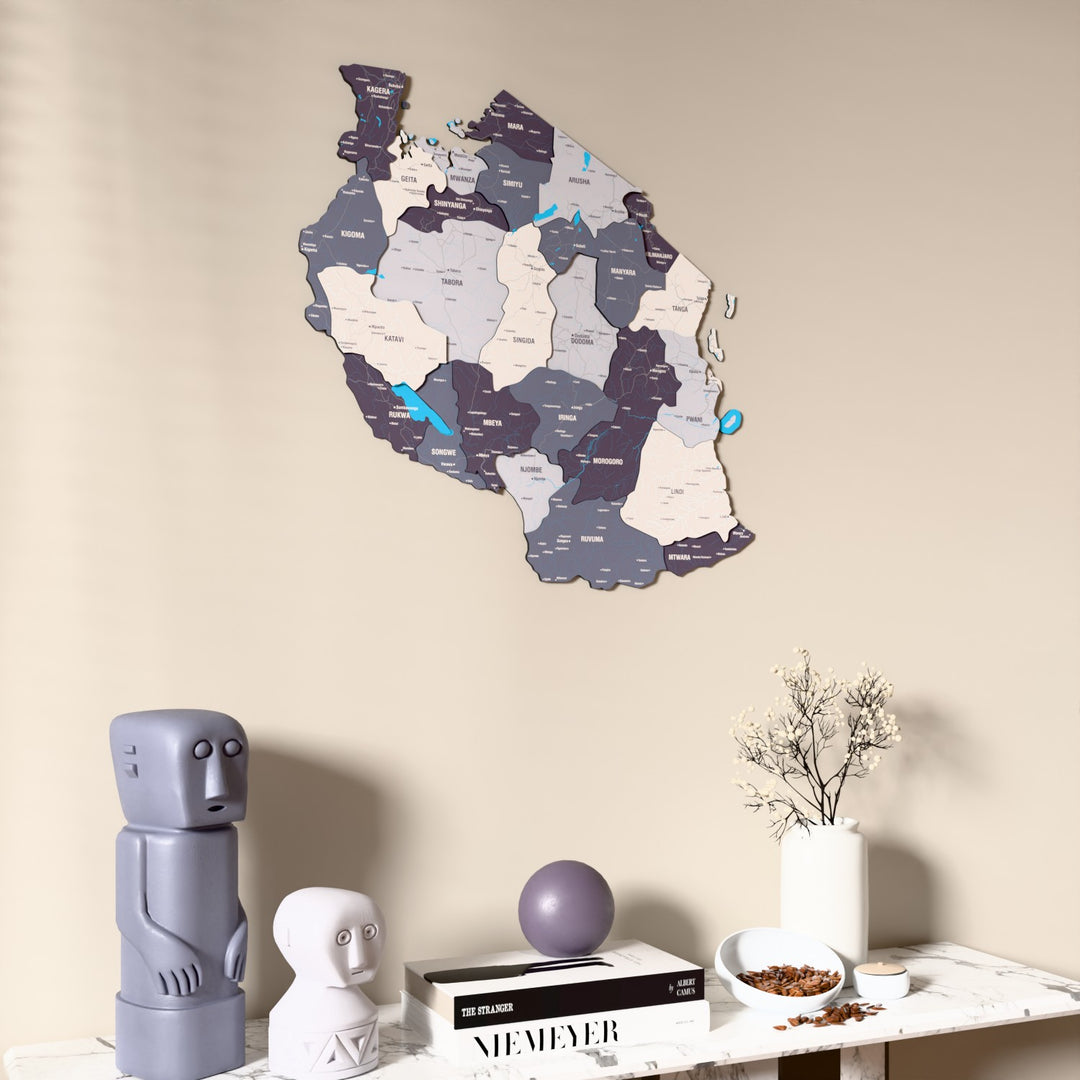 Nimbus Tanzania wooden wall map on a beige wall above a console with figurines