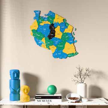 Flag colored Tanzania wooden wall map above a marble console, front view
