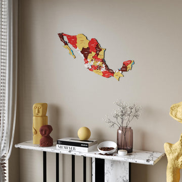 Terra Mexico wooden wall map in red, maroon and mustard states above a marble console table, sheer curtain at the left