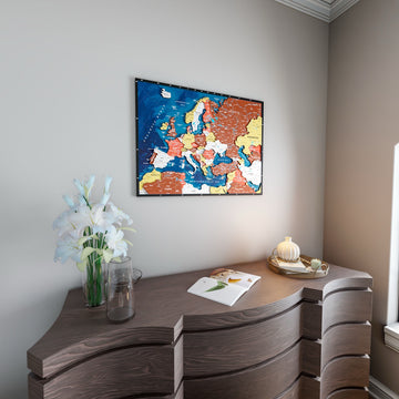 Wooden Europe map with rivers in Terracotta, above a curved wooden dresser with white lilies