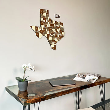 Close view of the Texas wooden map above a glossy desk with a laptop