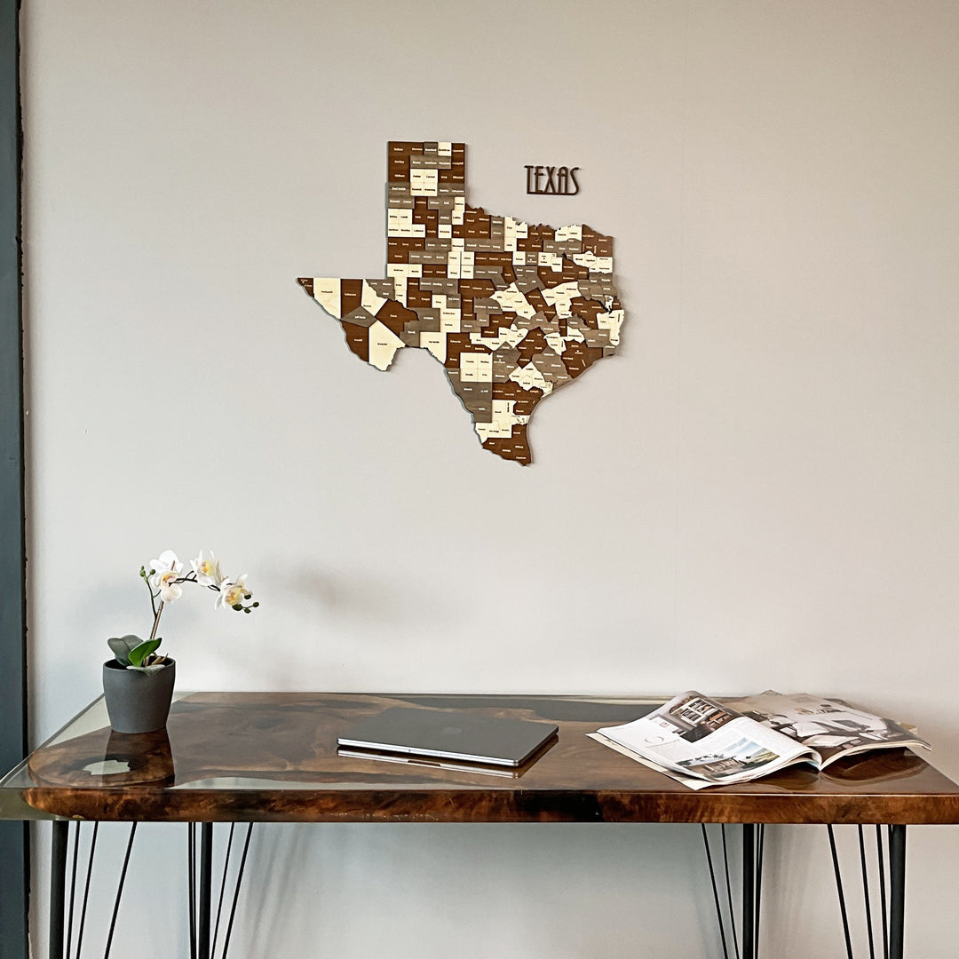 Texas wooden county map over a live-edge desk with an orchid, closer crop
