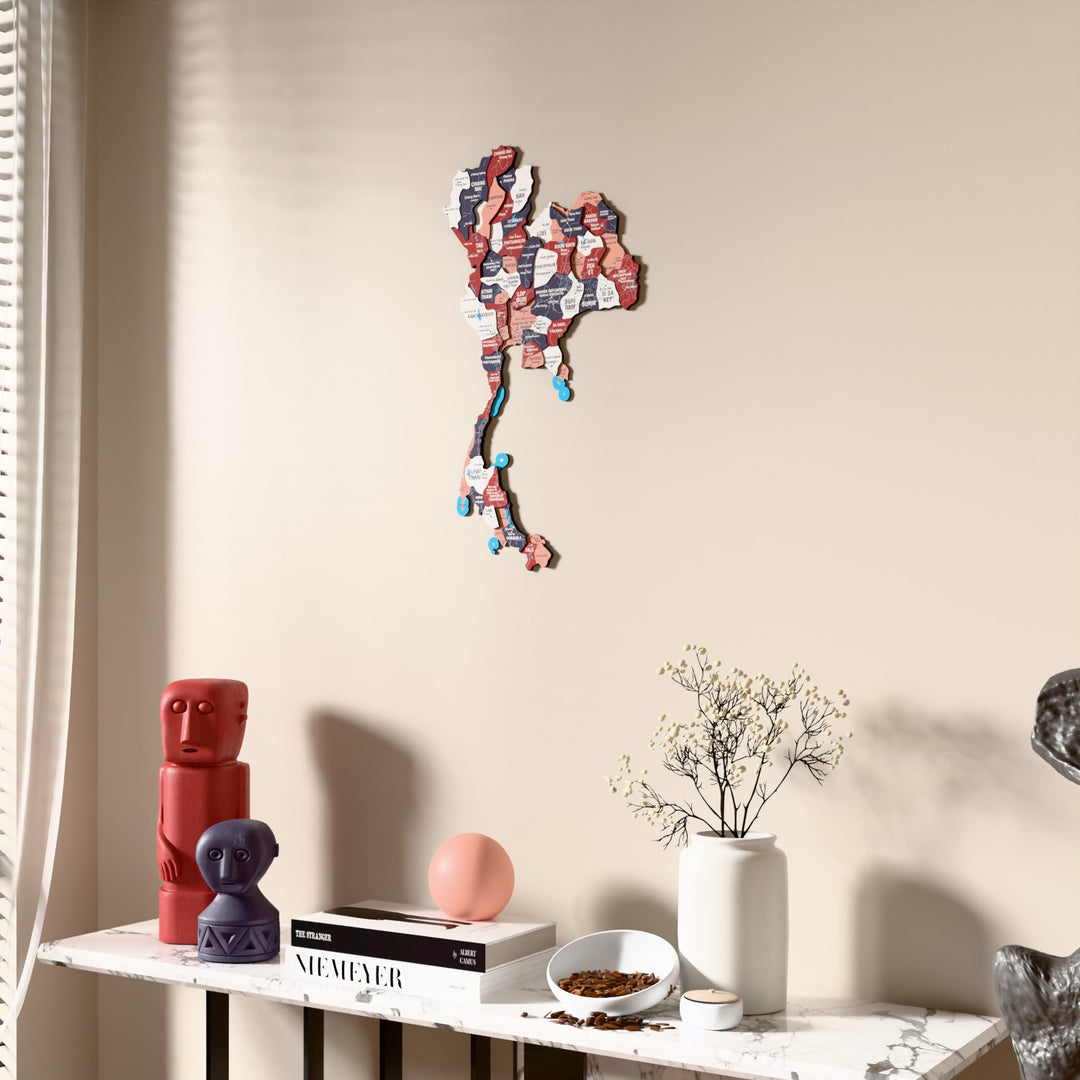 Flag colored Thailand wooden wall map beside a sheer curtain, angled view