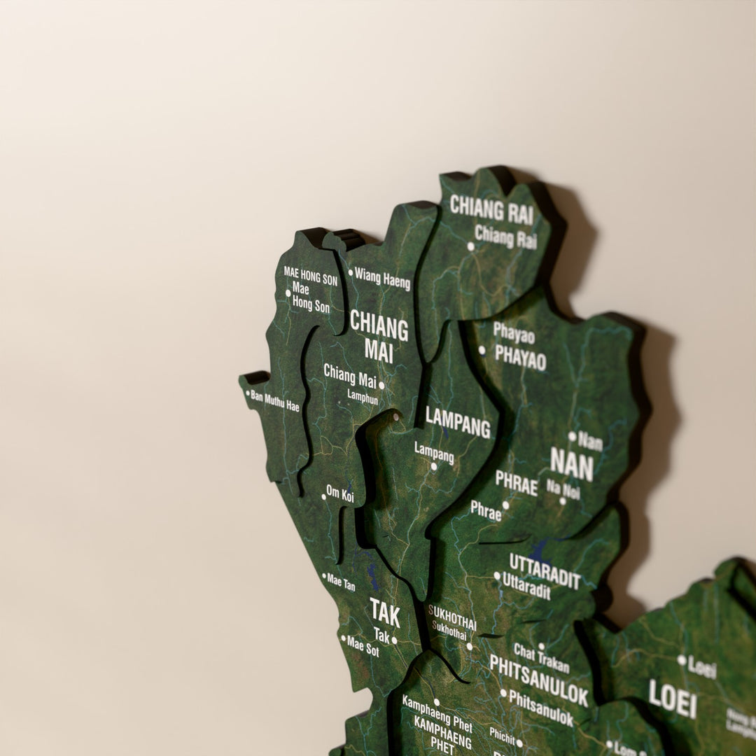 Close-up of the Satellite Thailand wooden wall map with layered regions and printed names
