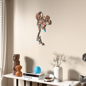 Soil Thailand wooden wall map beside a sheer curtain, angled view