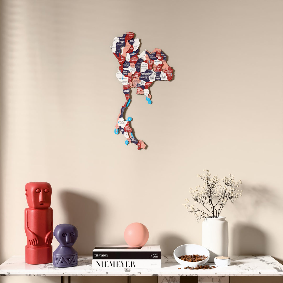 Flag colored Thailand wooden wall map above a marble console, front view