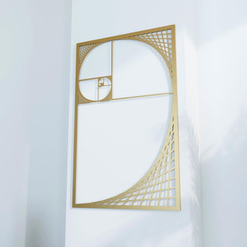 Close view of gold Golden Ratio spiral metal wall decor, angled and filling most of the frame