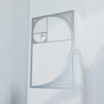 Close view of silver Golden Ratio spiral metal wall decor, angled and filling most of the frame