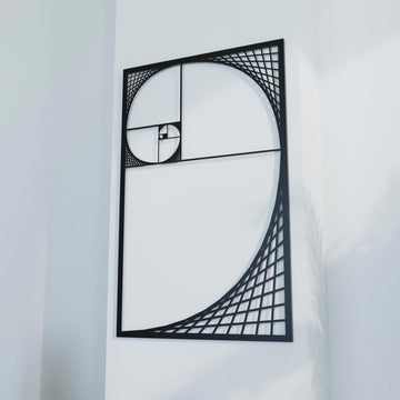 Close view of black Golden Ratio spiral metal wall decor, angled and filling most of the frame