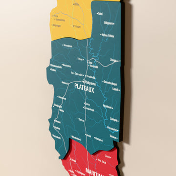 Close-up of the Flag colored Togo wooden wall map with layered regions and printed names