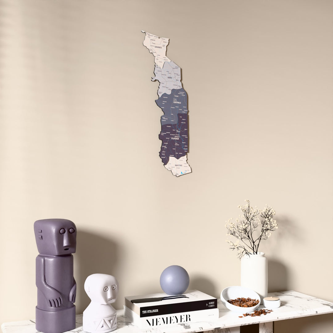 Nimbus Togo wooden wall map on a beige wall above a console with figurines