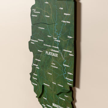 Close-up of the Satellite Togo wooden wall map with layered regions and printed names