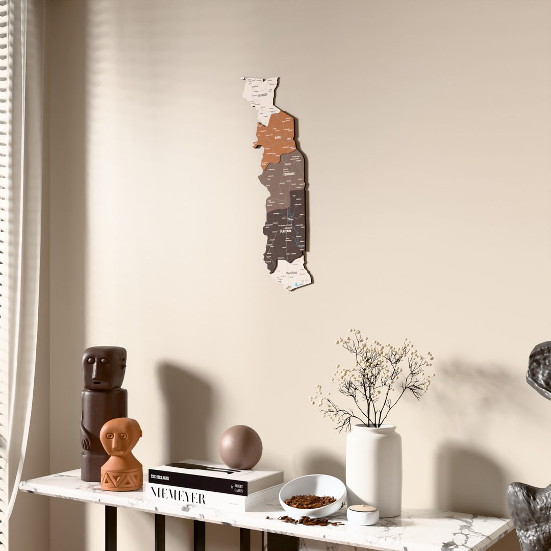 Soil Togo wooden wall map beside a sheer curtain, angled view