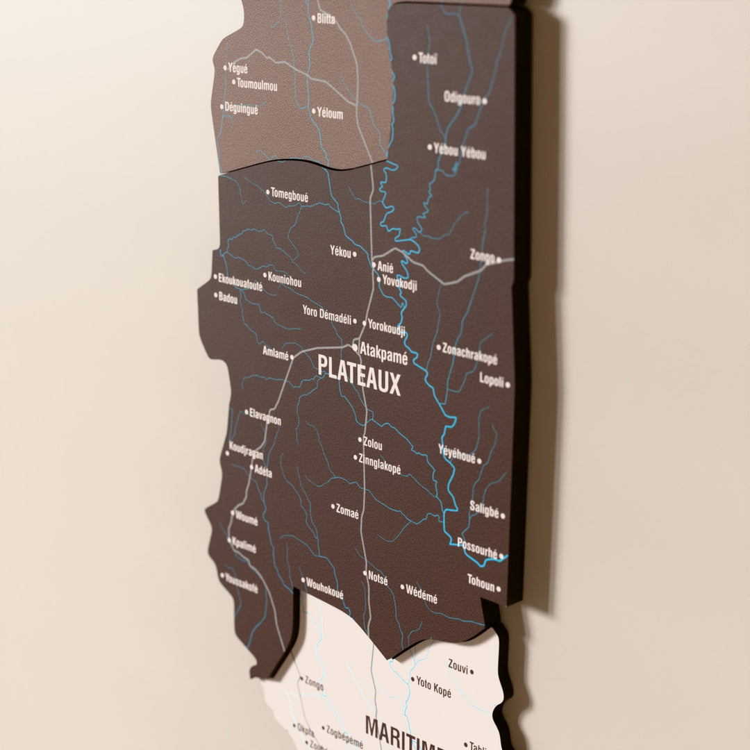 Close-up of the Soil Togo wooden wall map with layered regions and printed names