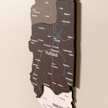Close-up of the Soil Togo wooden wall map with layered regions and printed names