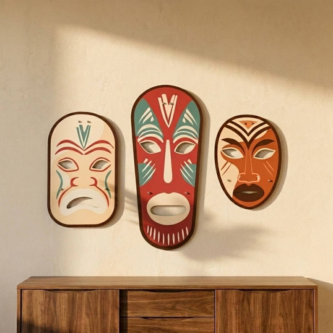Tribal masks 3-piece metal wall art set above a wooden console in sunlight