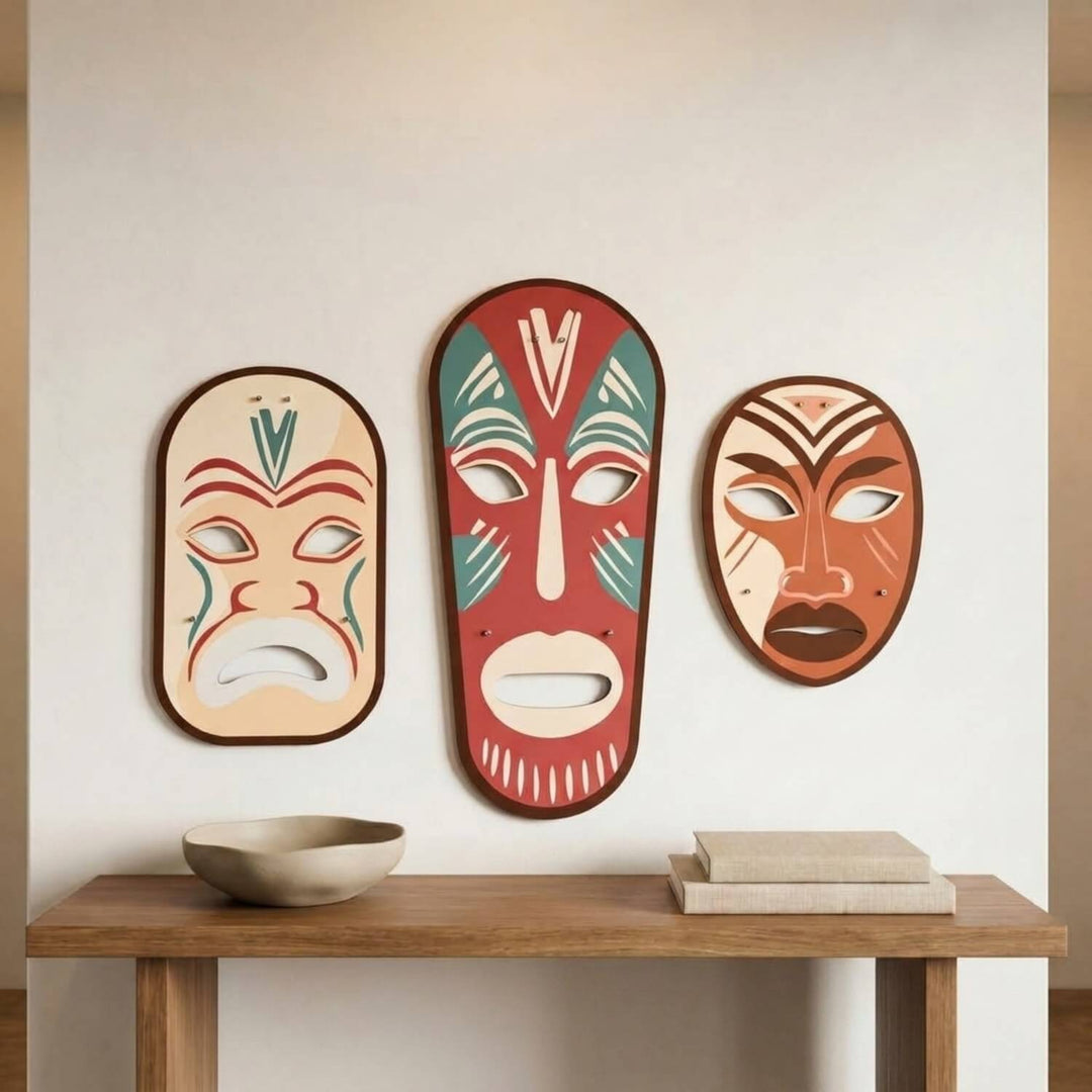 Tribal masks metal wall art set above a wooden table on a light wall