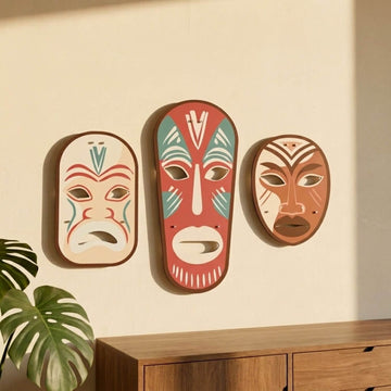 Tribal masks metal wall art set above a wooden cabinet, side light