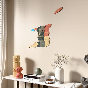 Sage Trinidad and Tobago wooden wall map beside a sheer curtain, angled view