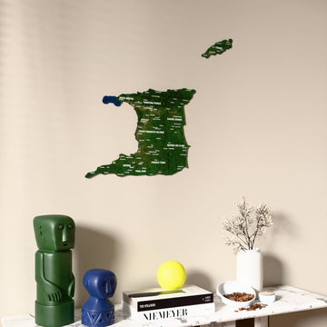 Satellite Trinidad and Tobago wooden wall map on a beige wall above a console with figurines