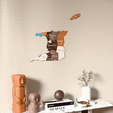 Soil Trinidad and Tobago wooden wall map on a beige wall above a console with figurines